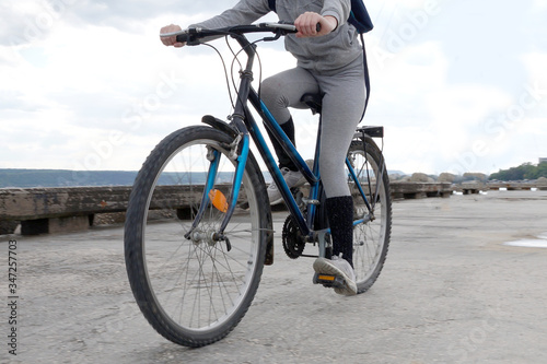 girl rides a bicycle on the pier 