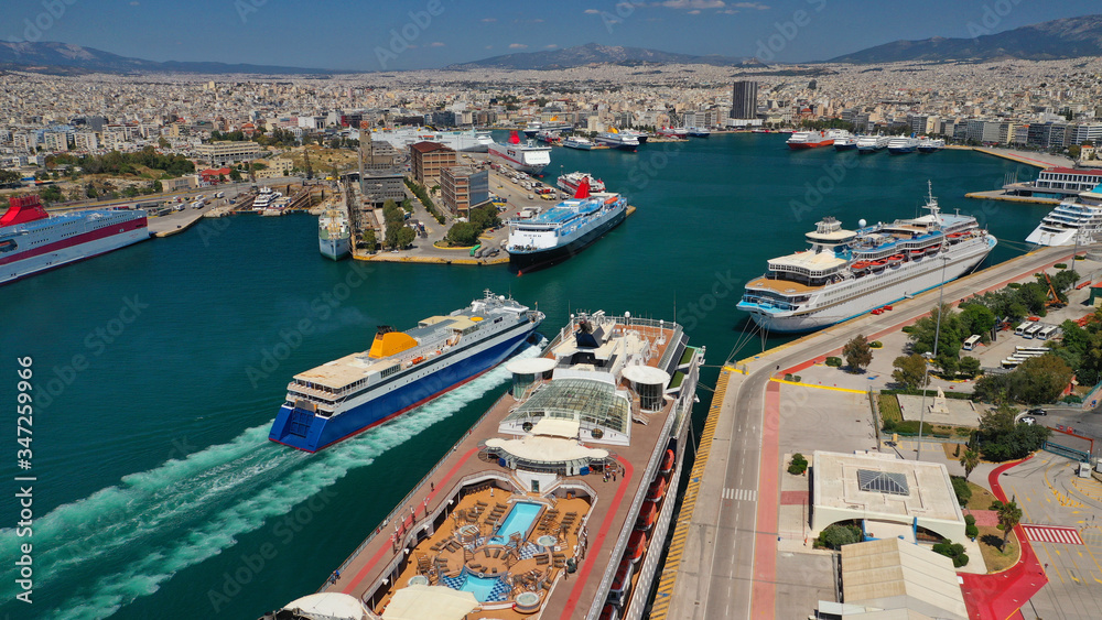 Aerial drone photo of passenger ferry reaching destination - busy port of Piraeus, Attica, Greece