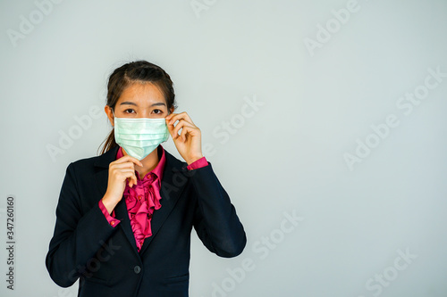 portrait of a businesswoman wearing medical protective face mask to prevent her health and standing at the whiite background copy space