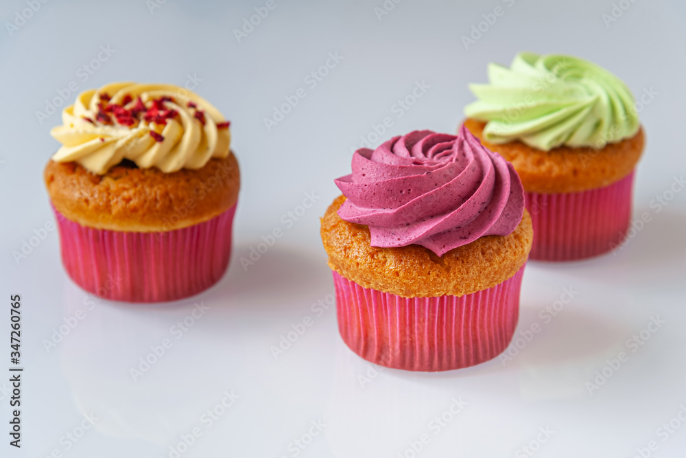 different cupcakes on a light glass surface close up