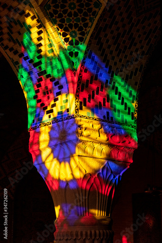 Nasir-ol-molk Mosque is full of colorful light in the morning. A column is painted in colorful colors from light through stained glass. Shiraz  Iran.