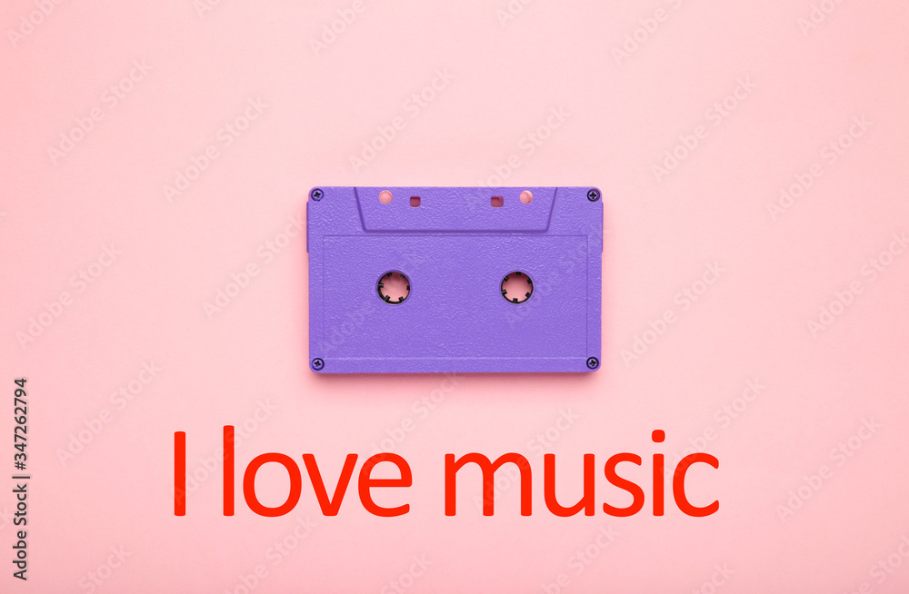 Obraz premium Inscription I love music with old colorful cassette on a pink background. Music day