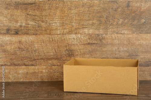 Cardboard box on the broun background. Copy space