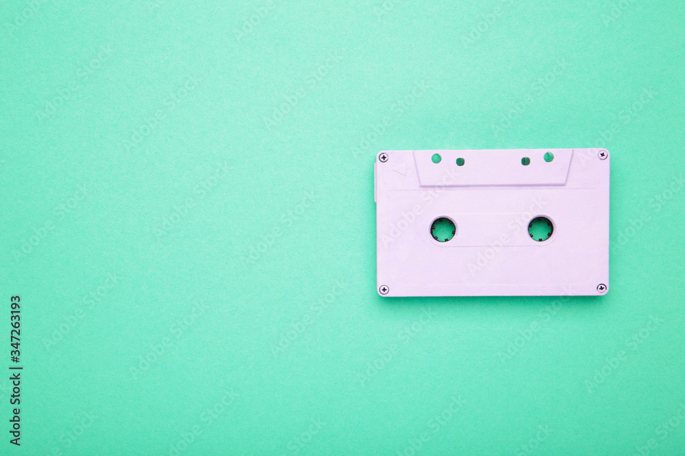 Old audio cassette on mint background. Music day Old audio cassette on mint background. Music day