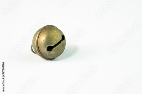 The bell on the white background is spherical