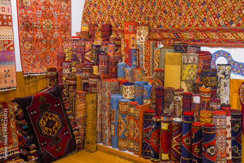Pile of beautiful handmade carpets on the open market bazaar. Turkish traditional design. © Alexe