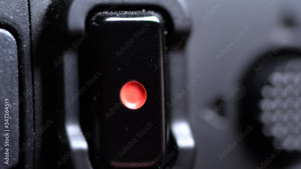 Macro of record button on a camera getting pressed