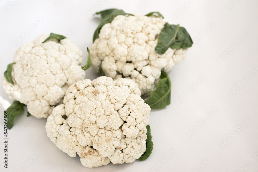 Three cauliflower scacans. They're going against a white background. Three cauliflower scacans. They're going against a white background.