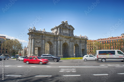 Puerta de Alcalá in summer with blurred cars.