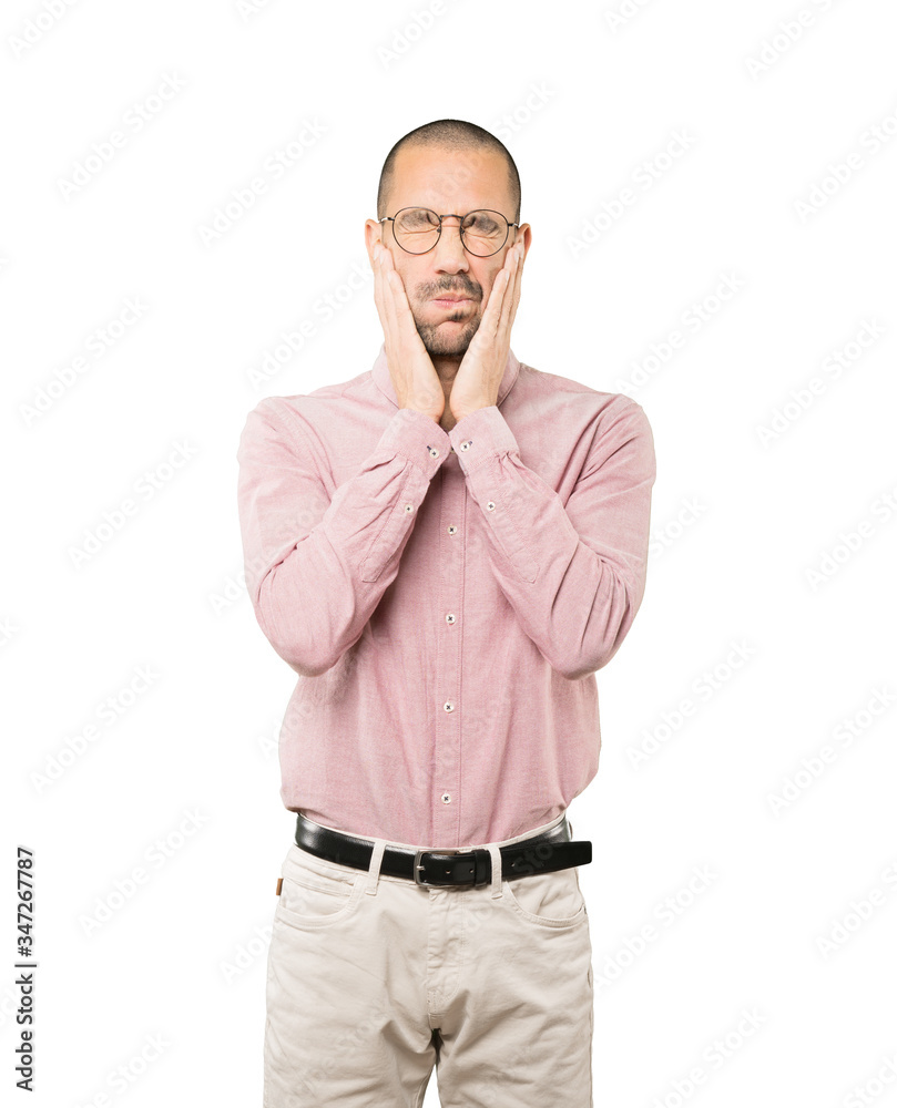 Concerned young man doing a gesture of relief Concerned young man doing a gesture of relief