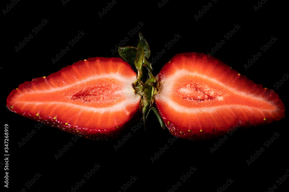 Strawberries on a black background. Strawberries are delicious fruits that are common in Romania, from start of may until the end of the summer