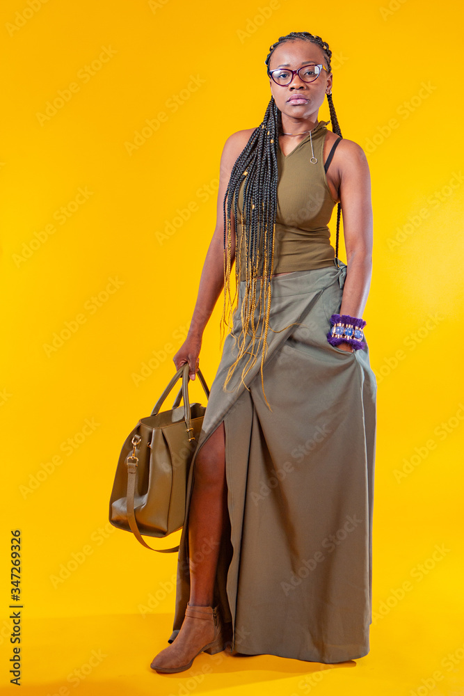 Casual style. African American. Girl with dreadlocks. Business woman. Business woman with dreadlocks. Girl from Africa. Dark-skinned model with a handbag. Woman with african pigtails.