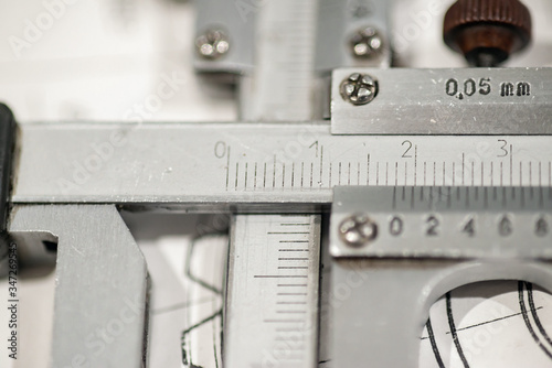 Scale of a measuring tool close-up, production and manufacture of a gear shaft and wheel.