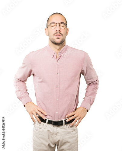 Tired young man posing against background