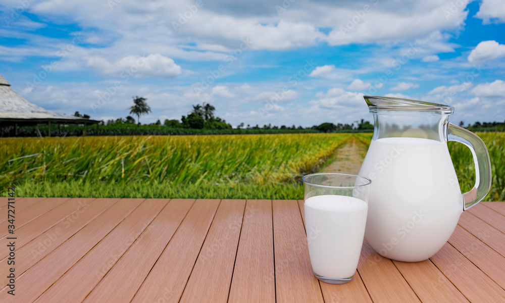Fresh milk in clear glass and clear pitcher on lath floor With a rice field background With golden yellow rice, bright sky, white clouds .3D Rendering Fresh milk in clear glass and clear pitcher on lath floor With a rice field background With golden yellow rice, bright sky, white clouds .3D Rendering