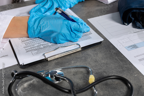 Картината върху платно The doctor completes the survey about staying abroad and quarantines in connection with the prevailing COVID-19