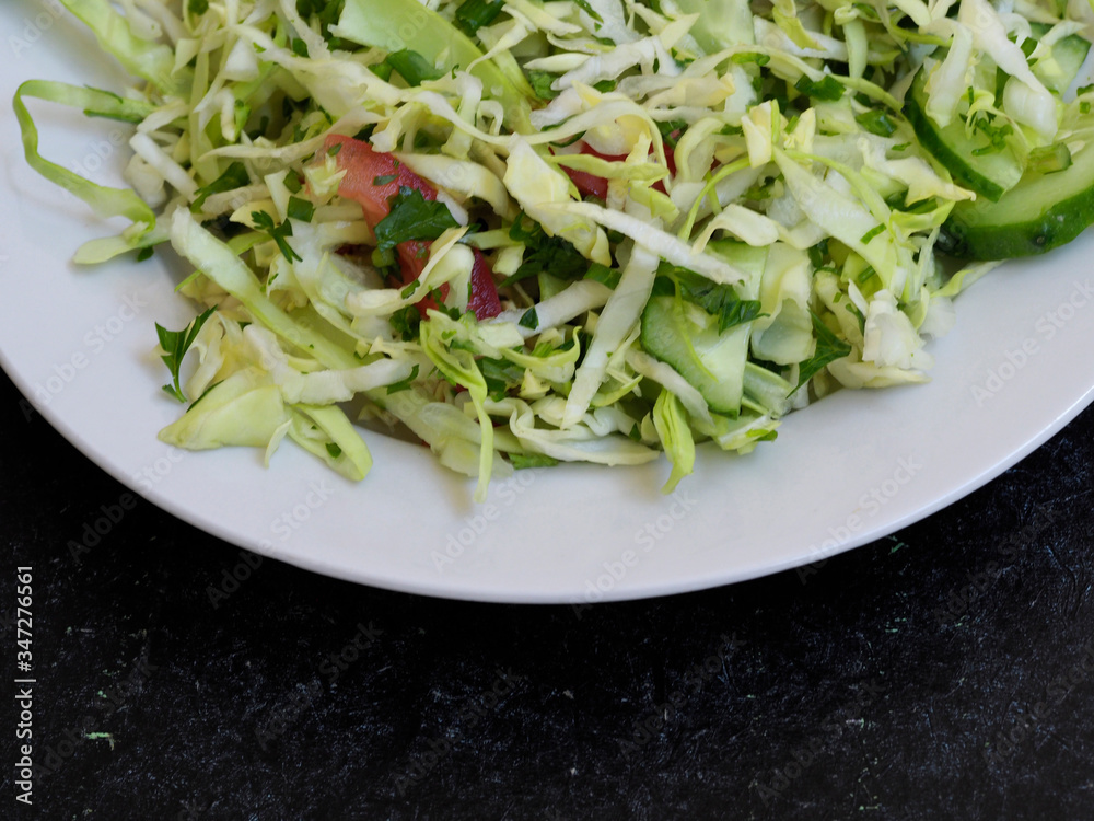 Cabbage salad and tomato on a plate. Dietary salad with fresh vegetables Cabbage salad and tomato on a plate. Dietary salad with fresh vegetables