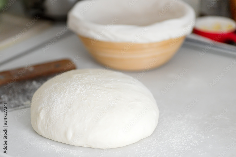 Homemade freshly prepared dough for fresh healthy bakery and pastry on a white kitchen table. Homemade freshly prepared dough for fresh healthy bakery and pastry on a white kitchen table.