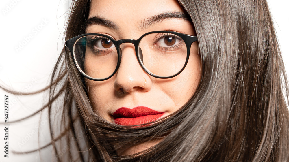 Portrait of young woman wearing eyeglasses and posing on camera Portrait of young woman wearing eyeglasses and posing on camera