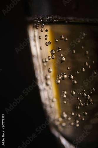 Champagne bubbles in a glass on a dark background