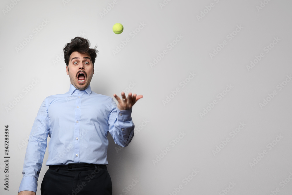 Dark hair bearded hipster with tennis ball. Businessman well groomed enjoy free time over white background. Isolated. Dark hair bearded hipster with tennis ball. Businessman well groomed enjoy free time over white background. Isolated.
