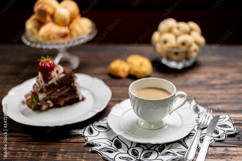 Coffee cup and chocolate cake on wooden table background Coffee cup and chocolate cake on wooden table background