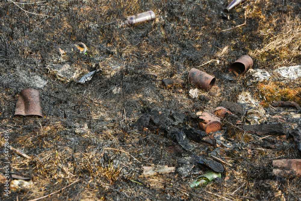 Obraz premium environmental pollution concept. unauthorized dump. burnt grass and landfill in it