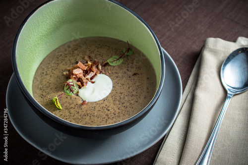 Vegetable cream soup with bacon and sour cream