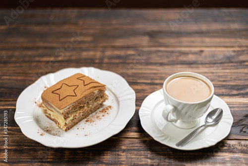 Coffee cup and chocolate cake on wooden table background