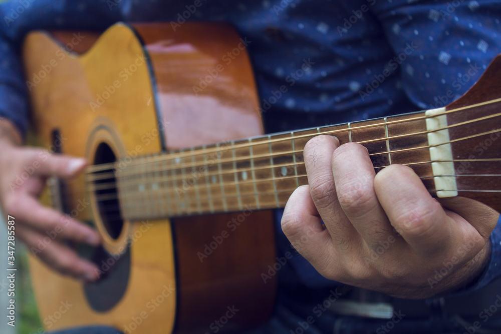 Fototapeta premium Young guy plays guitar
