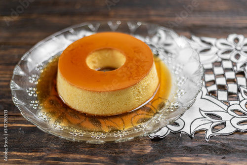 Milk Pudding or Pudim de leite. Brazilian dessert homemade caramel custard pudding. Traditional brazilian flan on wooden background