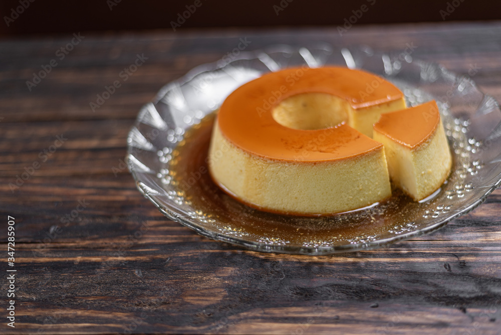 Milk Pudding or Pudim de leite. Brazilian dessert homemade caramel custard pudding. Traditional brazilian flan on wooden background Milk Pudding or Pudim de leite. Brazilian dessert homemade caramel custard pudding. Traditional brazilian flan on wooden background