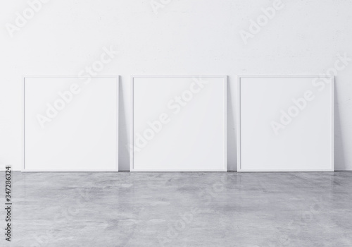 Three white square frames Standing on concrete gray floor with white background, minimal frame mock up interior  photo