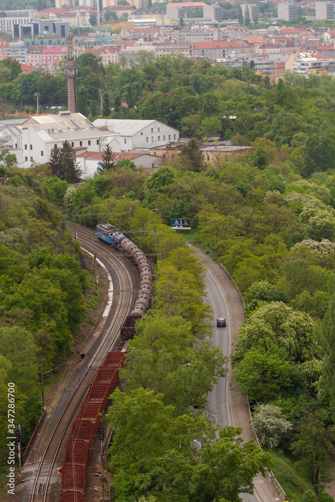 
passing train on tracks in the forest in the capital of the Czech Republic Prague