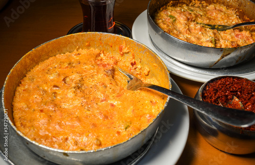 Traditional turkish food breakfast dish menemen made by eggs and tomatoes and different fillings