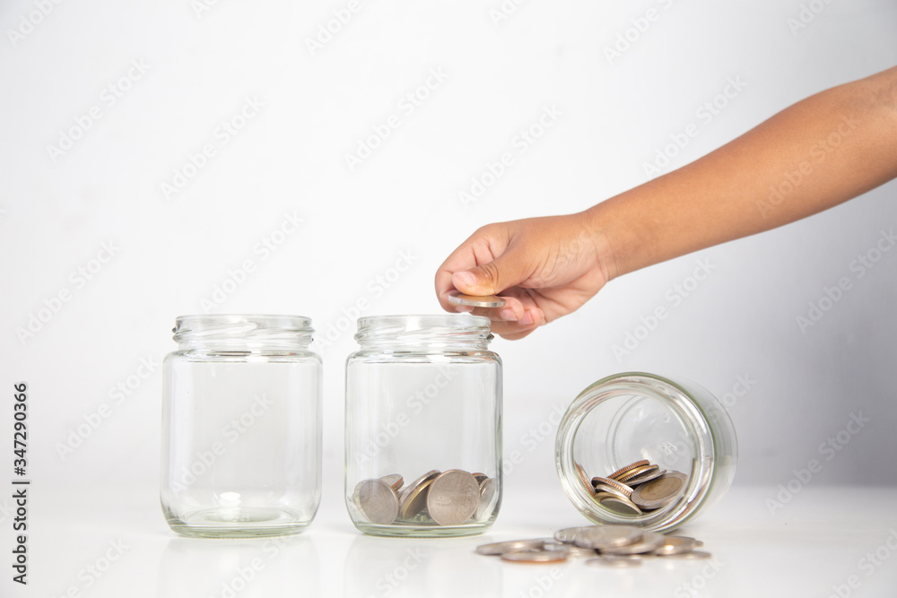 child's hand holding a coin in a glass bottle,.Concept: saving coin family money for home dreams,.symbol growing investment success wealth to benefit,.business growth banking for cash child's hand holding a coin in a glass bottle,.Concept: saving coin family money for home dreams,.symbol growing investment success wealth to benefit,.business growth banking for cash