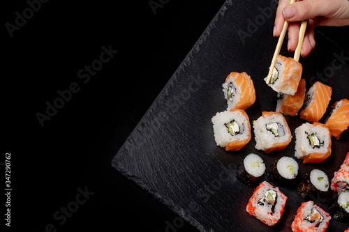 Set of sushi roll on black slate background food fish philadelphia japanese salmon delicious sushi rice cucumber meal traditional wasabi fresh healthy gourmet raw cuisine