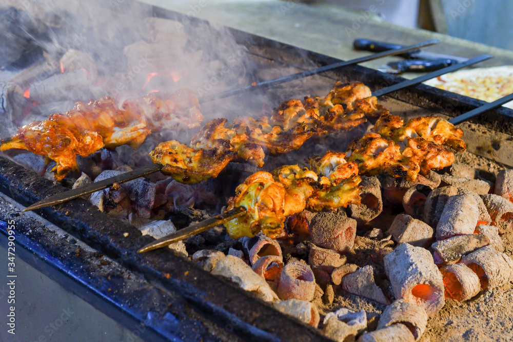 Roasted meat cooked at barbecue. Grilled kebab cooking on metal skewer. BBQ fresh beef meat Roasted meat cooked at barbecue. Grilled kebab cooking on metal skewer. BBQ fresh beef meat
