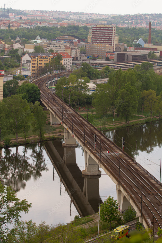 
railway bridge in Prague over the Vltava river in the spring of 2020 in the Czech Republic. reflections can be seen on the surface