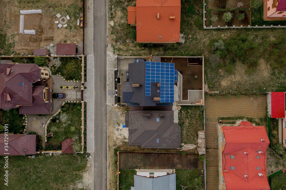 Aerial top view of a house with paved yard with green grass lawn with concrete foundation floor Aerial top view of a house with paved yard with green grass lawn with concrete foundation floor