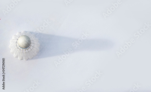 plastic  Badminton shuttlecock. Macro horizontal banner of a plastic  shuttlecock with shadow on the white background. Design of a shuttlecock. Badminton accessories. Sports equipment. place for text