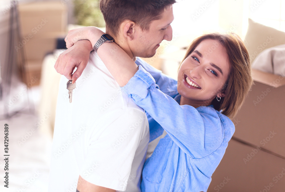 Happy couple hugging in their new house Happy couple hugging in their new house