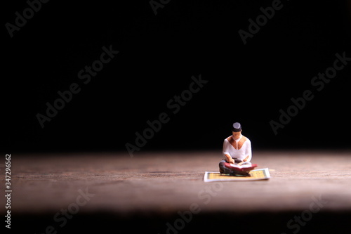 Conceptual Photo, Sitting Muslim, Islam People Reading Al Quran, at Wooden Floor