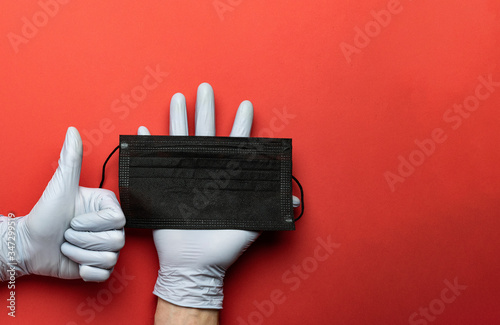 Medical disposal, lab gloves - Virus protection equipment on red background. Infections prevention CoronaVirus pandemic protection by washing hands frequently. Professional safety and hygiene.