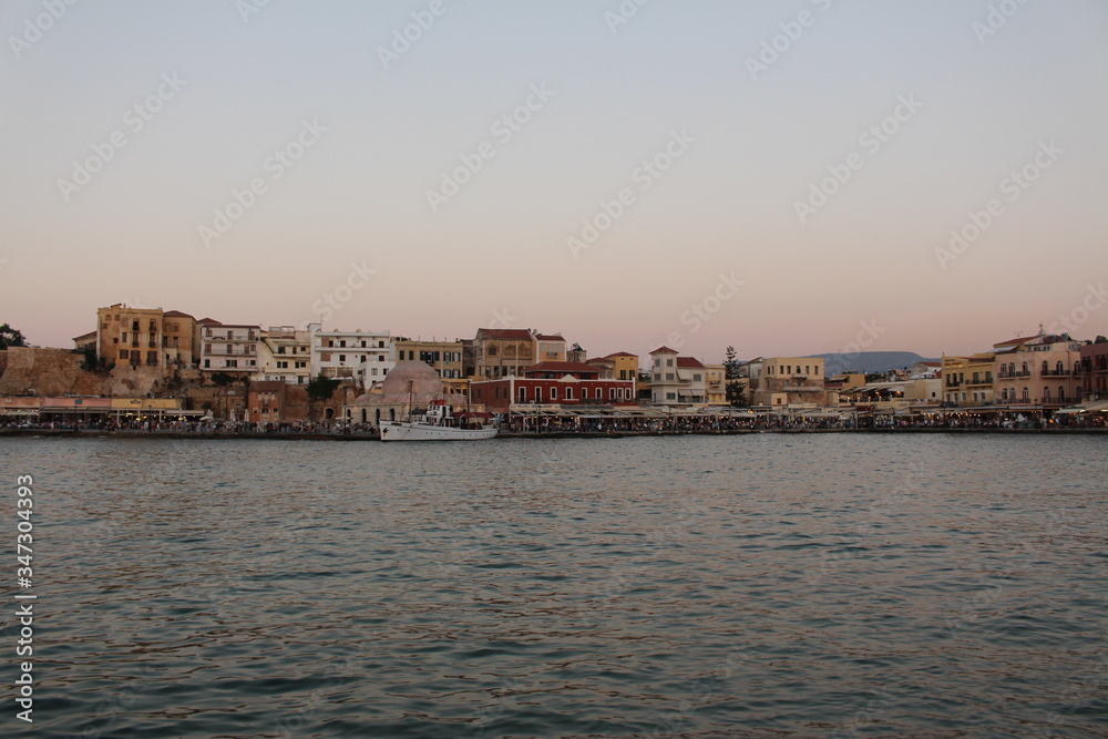 A view of old Venetian Harbor of Chania with historical buildings in Crete Island, Greece.
