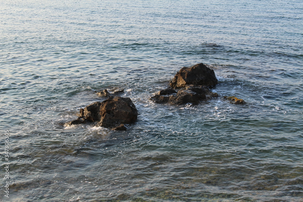 Mediterranean sea waves splashing at the rocks with foam in Chania, Crete Island, Greece. Mediterranean sea waves splashing at the rocks with foam in Chania, Crete Island, Greece.