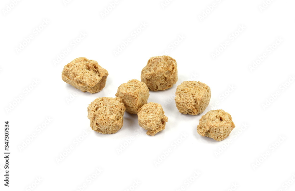 Raw dehydrated soy meat on white background. Pieces of dry soy meat. Textured Soy Protein. Raw dehydrated soy meat on white background. Pieces of dry soy meat. Textured Soy Protein.