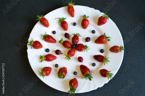 Sliced strawberries are decoratively placed on a white plate