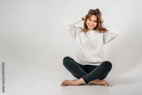 Happy beautiful young woman looking to the camera at white copyspace