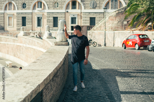 Nice boy posing in Rome during a sunny day untile the sunset photo